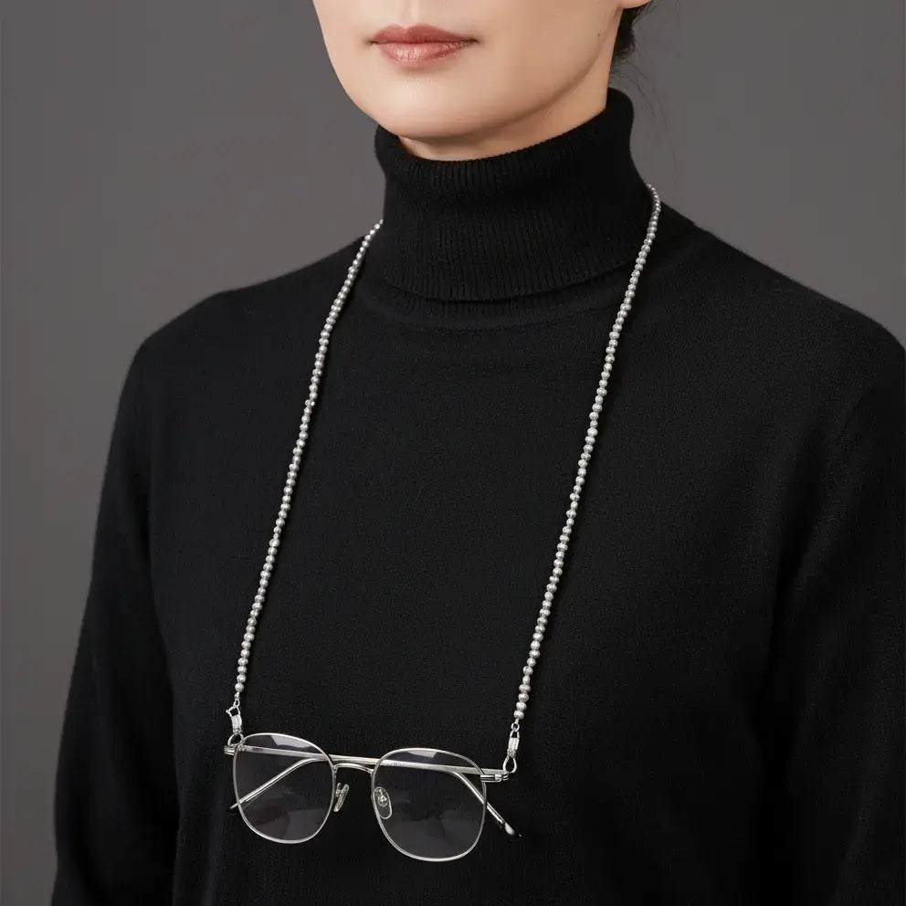 Eternal Grace baroque pearl eyewear chain worn around the neck like a necklace, showcasing its soft luster and versatile design.