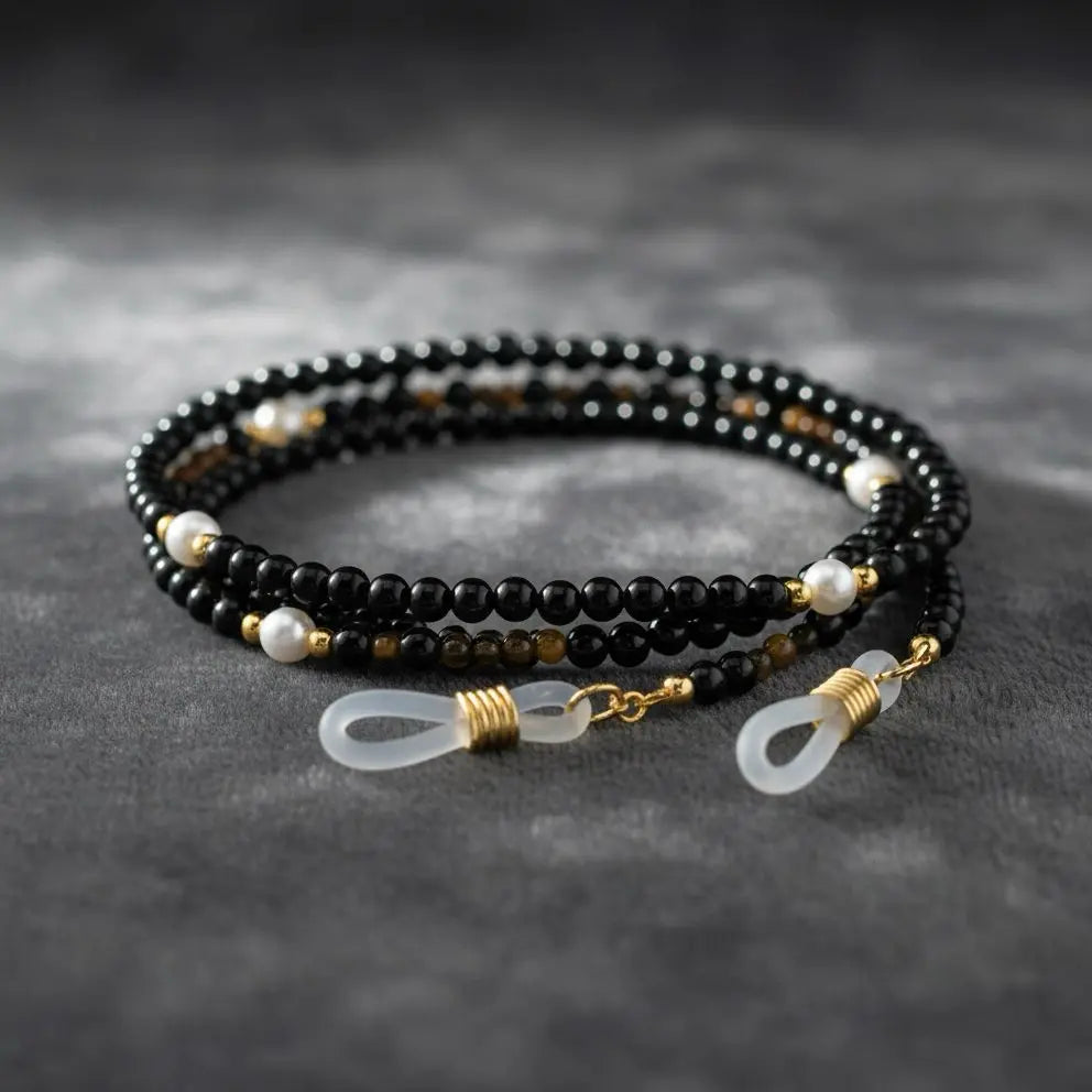 Close-up detail of black agate gemstone beads and silver accents from the Guardian’s Grace eyewear chain by Oculux Jewelry.