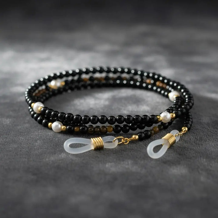 Close-up detail of black agate gemstone beads and silver accents from the Guardian’s Grace eyewear chain by Oculux Jewelry.