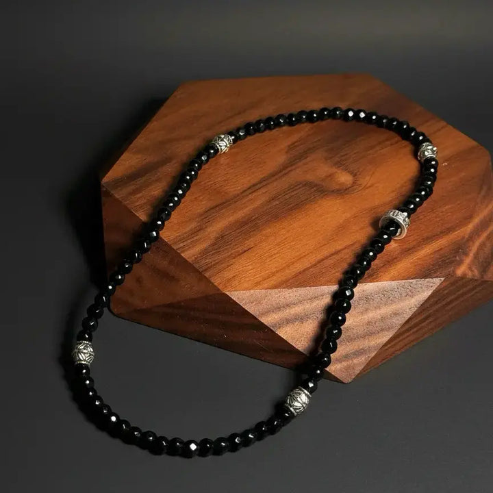 Black agate double wrap bracelet handmade with faceted gemstone beads, designed by Oculux Jewelry.