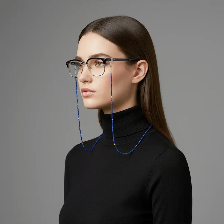 Model wearing the Wisdom of the Sky lapis lazuli eyewear chain attached to glasses, expressing calm sophistication and balance by Oculux Jewelry.