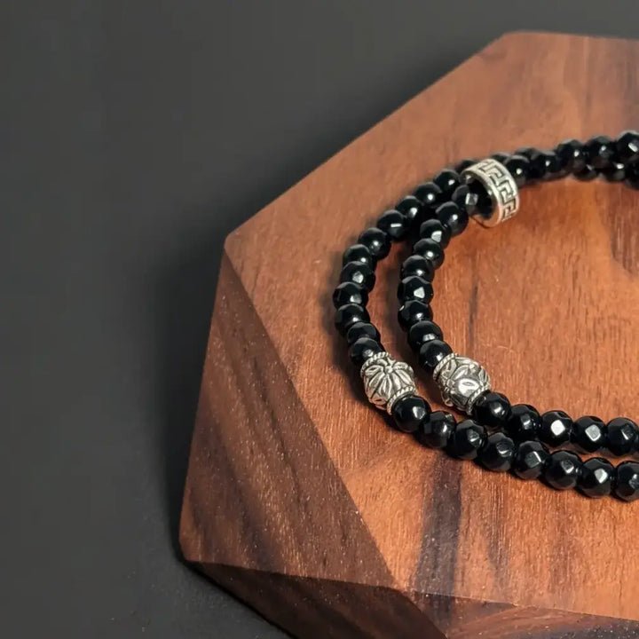 Black agate double wrap bracelet handmade with faceted gemstone beads, designed by Oculux Jewelry.