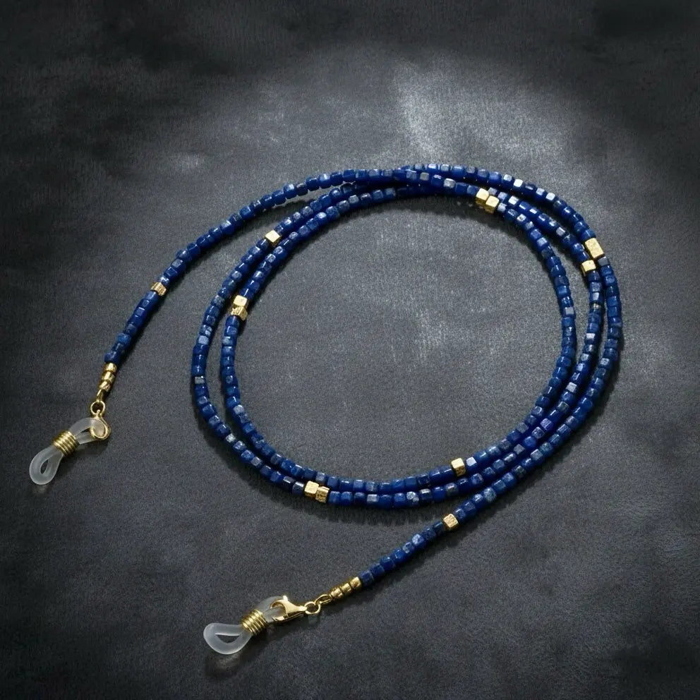 Lapis lazuli eyeglass chain displayed on velvet background, featuring deep blue gemstone beads and elegant handmade details by Oculux Jewelry.