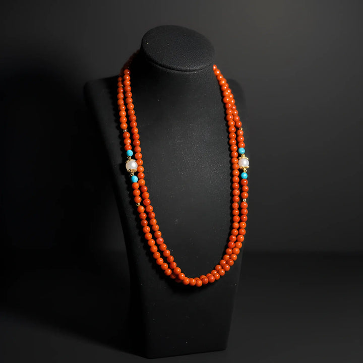Red agate eyewear chain displayed as a necklace on a jewelry stand, emphasizing natural gemstone texture and warm vitality by Oculux Jewelry.