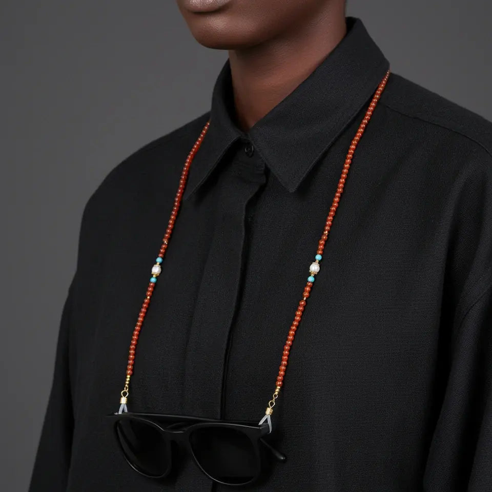 Flame of Vitality red agate eyewear chain worn around the neck like a necklace, showcasing its vibrant gemstone color and versatile design.